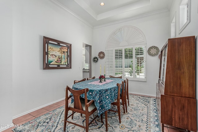 dining space featuring light tile patterned floors, a raised ceiling, baseboards, ornamental molding, and recessed lighting