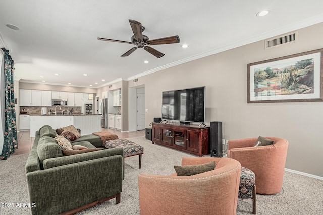 living area with baseboards, a ceiling fan, visible vents, and recessed lighting