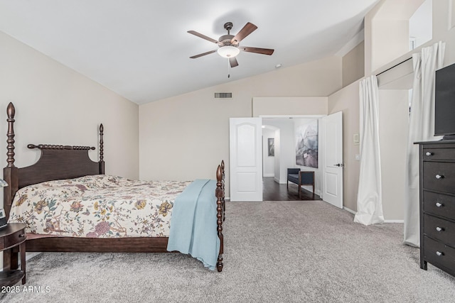 carpeted bedroom featuring vaulted ceiling, visible vents, and a ceiling fan