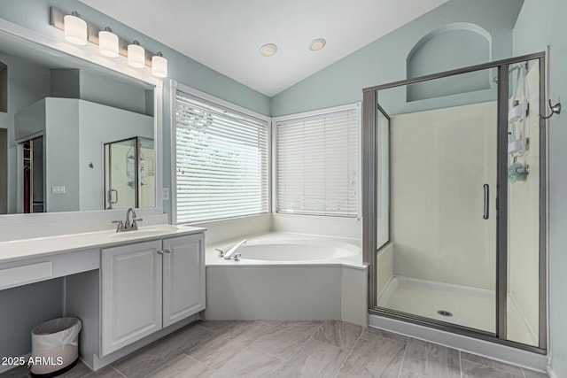 full bath with a garden tub, vanity, and a stall shower