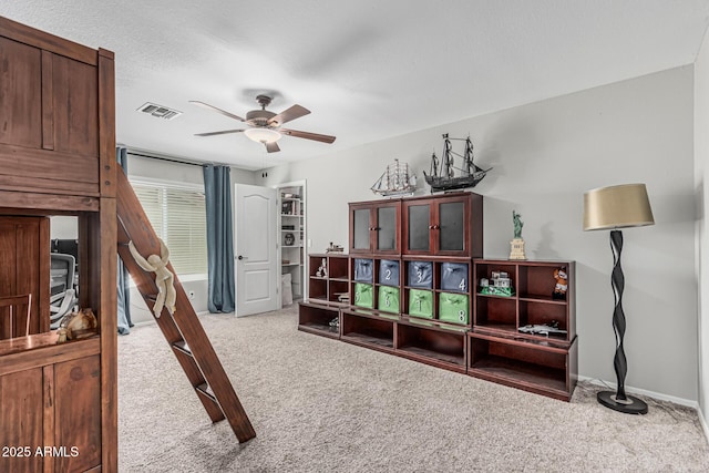 interior space featuring baseboards, visible vents, and carpet floors