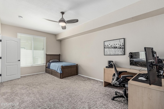 carpeted bedroom featuring baseboards and ceiling fan
