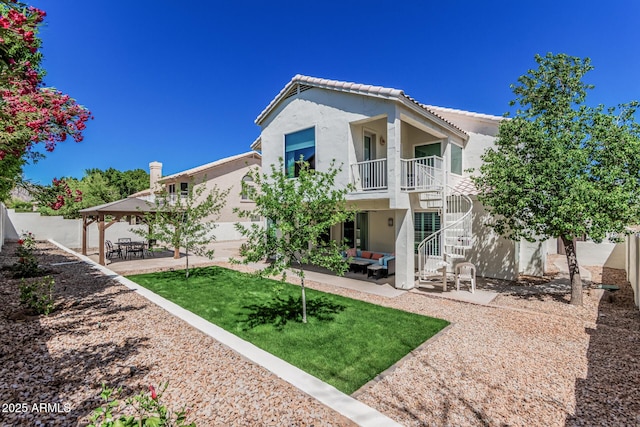back of house featuring stairway, an outdoor hangout area, a gazebo, and stucco siding