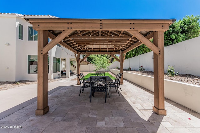 view of patio / terrace featuring a gazebo, a fenced backyard, and outdoor dining area