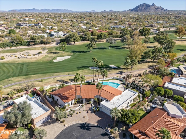 drone / aerial view with a mountain view and view of golf course
