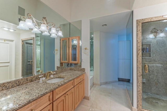 bathroom with vanity, baseboards, visible vents, a shower stall, and tile patterned floors
