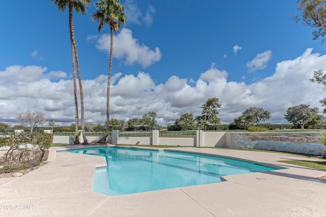 view of swimming pool featuring a patio area, a fenced in pool, and fence