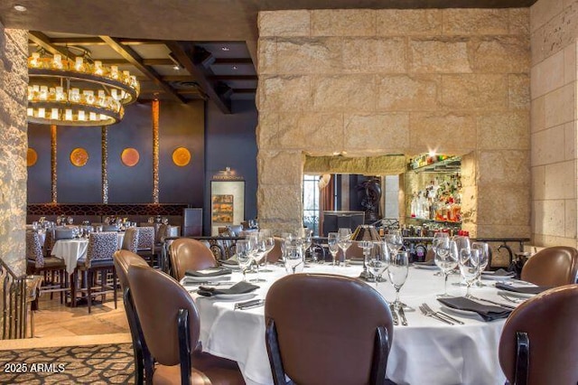 dining area with beamed ceiling and a notable chandelier