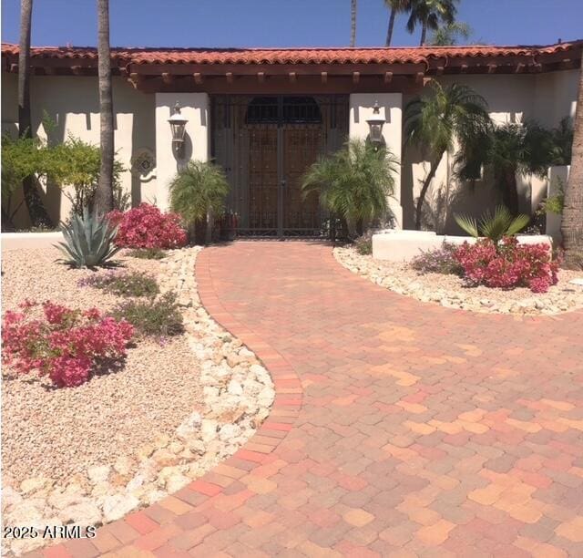 view of front of property with stucco siding and a tile roof