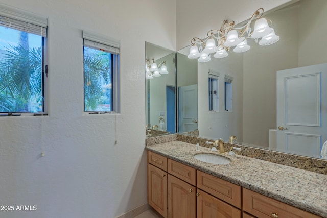 bathroom with vanity and a chandelier