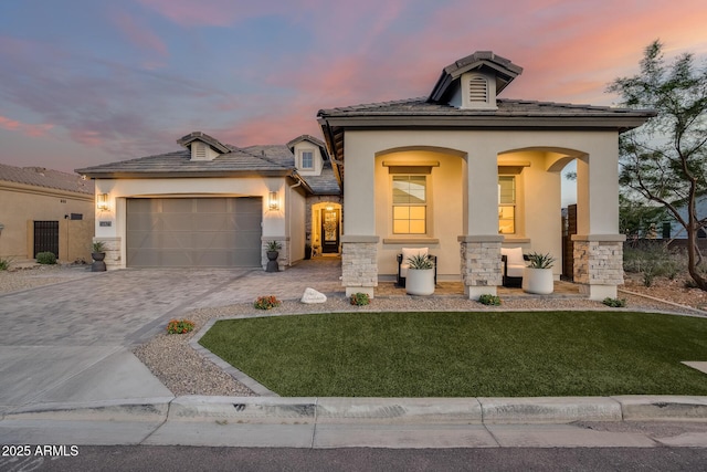 5901 E Sierra Morena St, Mesa, AZ 85215 - view of front of house with decorative driveway, a garage, stone siding, and stucco siding