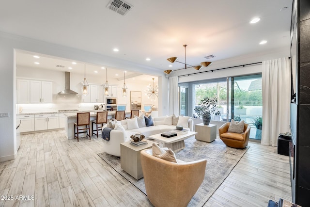 5901 E Sierra Morena St, Mesa, AZ 85215 - living area featuring visible vents, recessed lighting, light wood-style flooring, and a notable chandelier