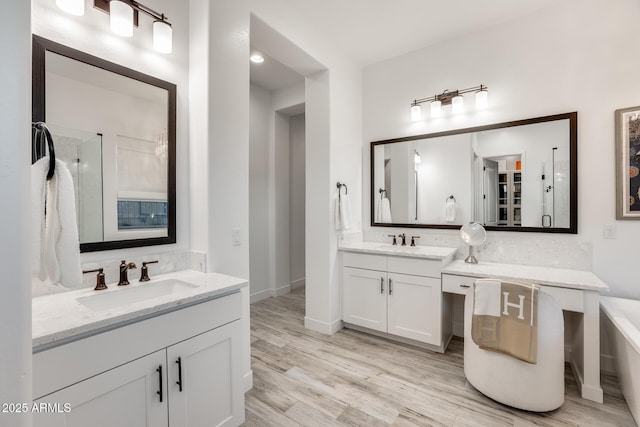 5901 E Sierra Morena St, Mesa, AZ 85215 - bathroom with a sink, wood finished floors, two vanities, and tiled shower