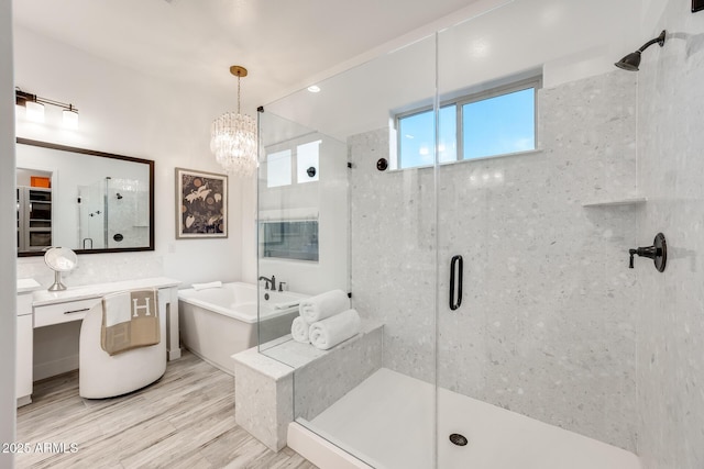 5901 E Sierra Morena St, Mesa, AZ 85215 - full bathroom with vanity, a freestanding bath, a chandelier, and a shower stall