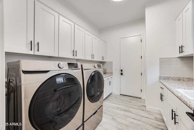 5901 E Sierra Morena St, Mesa, AZ 85215 - laundry area featuring cabinet space, baseboards, washer and clothes dryer, and light wood-style flooring