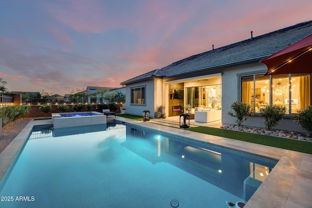 5901 E Sierra Morena St, Mesa, AZ 85215 - pool at dusk with a patio, a pool with connected hot tub, and a fenced backyard