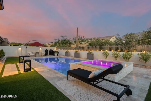 5901 E Sierra Morena St, Mesa, AZ 85215 - pool at dusk with a fenced backyard, a fenced in pool, a jacuzzi, and a patio area
