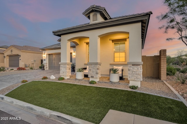 5901 E Sierra Morena St, Mesa, AZ 85215 - mediterranean / spanish-style home with stucco siding, a front yard, driveway, and stone siding