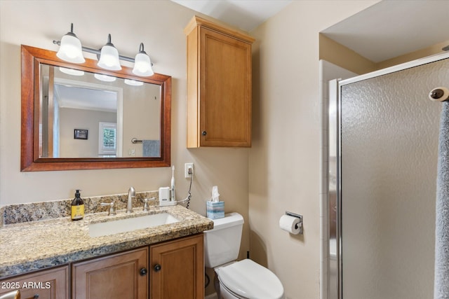 full bathroom with vanity, a stall shower, and toilet