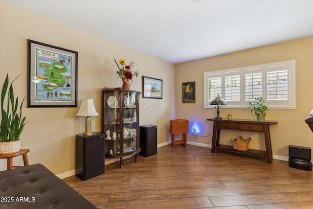 sitting room featuring baseboards and wood finished floors