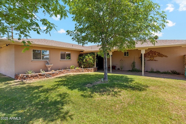 ranch-style home with a front yard and brick siding