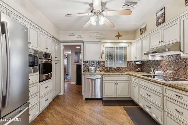 kitchen with a ceiling fan, visible vents, appliances with stainless steel finishes, under cabinet range hood, and a sink
