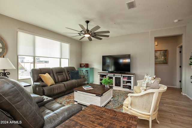 living room with hardwood / wood-style flooring and ceiling fan