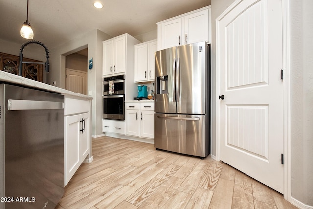 kitchen featuring light hardwood / wood-style floors, white cabinetry, and stainless steel appliances