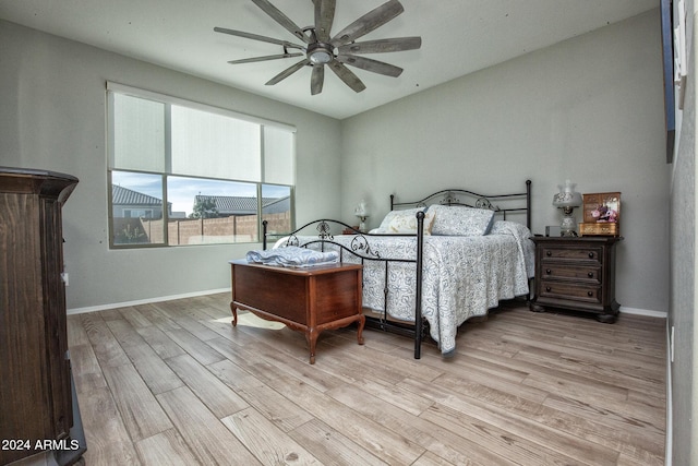 bedroom with ceiling fan and light hardwood / wood-style floors