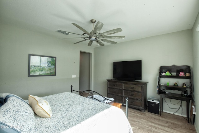 bedroom with light hardwood / wood-style flooring and ceiling fan