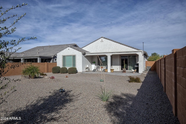 rear view of property featuring a patio