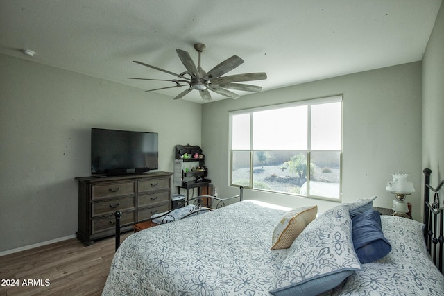 bedroom with ceiling fan and wood-type flooring