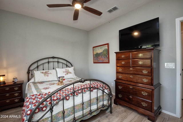 bedroom with ceiling fan and light hardwood / wood-style floors