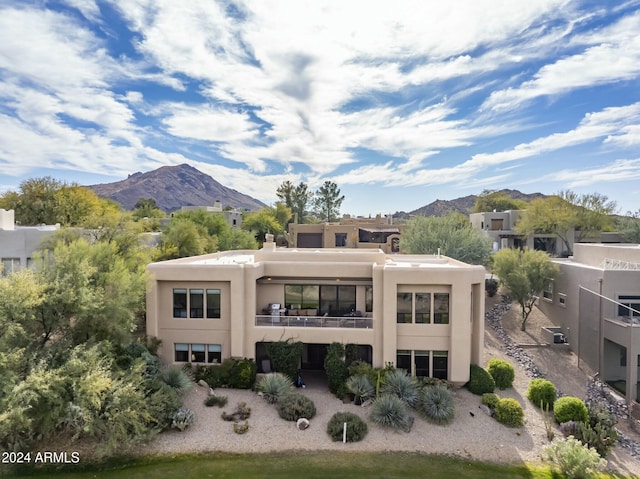 back of house with a mountain view