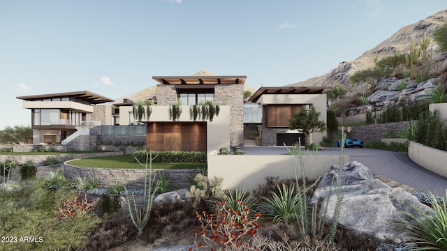 view of front of property with a balcony and a mountain view