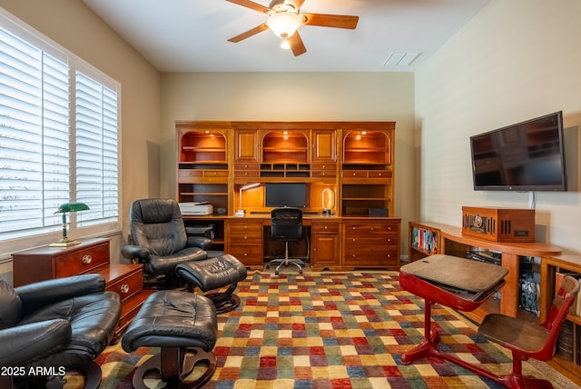 office space featuring ceiling fan, carpet flooring, and visible vents