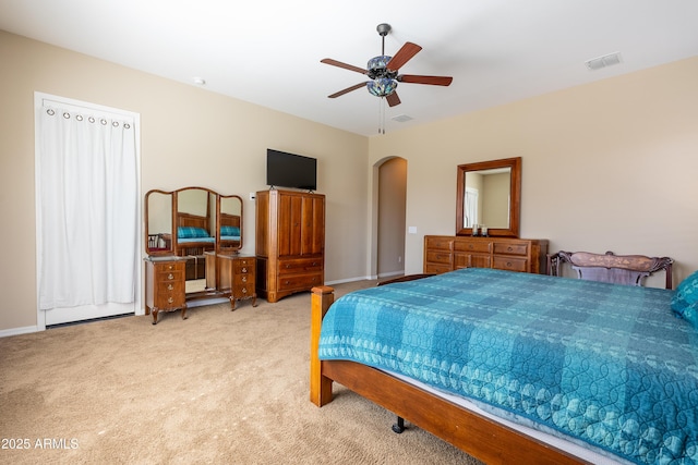 bedroom with arched walkways, visible vents, carpet flooring, ceiling fan, and baseboards