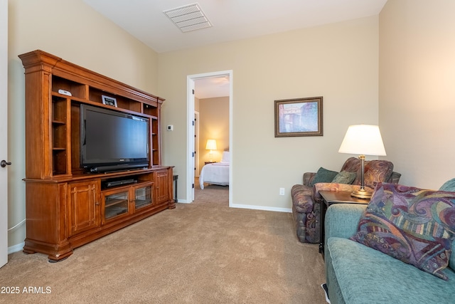 living area featuring baseboards, visible vents, and light colored carpet