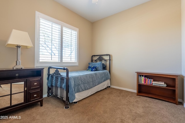 bedroom featuring carpet and baseboards