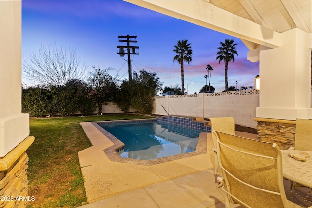 view of swimming pool with a lawn, a patio area, and a fenced backyard