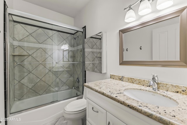 full bathroom with toilet, shower / bath combination with glass door, and vanity