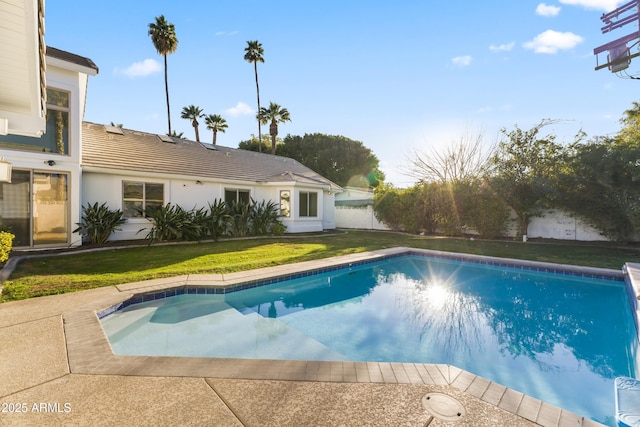 pool with a lawn and fence