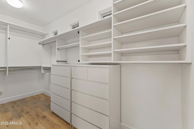 walk in closet with light wood-type flooring