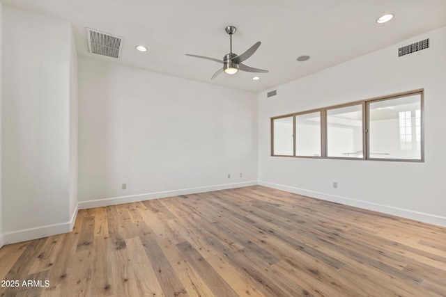 unfurnished room with light wood-style flooring, visible vents, and recessed lighting