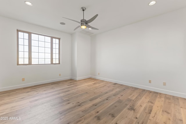 unfurnished room with recessed lighting, wood finished floors, a ceiling fan, and baseboards