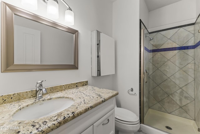 full bathroom featuring toilet, a shower stall, and vanity