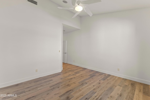 empty room with light wood-type flooring, baseboards, visible vents, and a ceiling fan