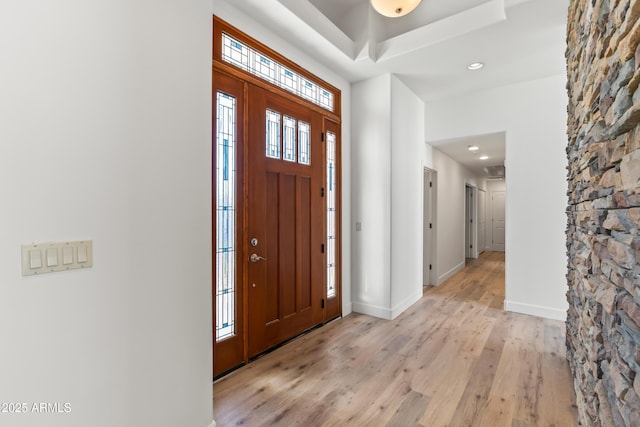 entryway featuring light wood finished floors, recessed lighting, and baseboards