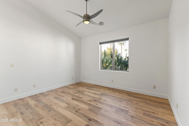 unfurnished room with light wood-style floors, baseboards, vaulted ceiling, and a ceiling fan