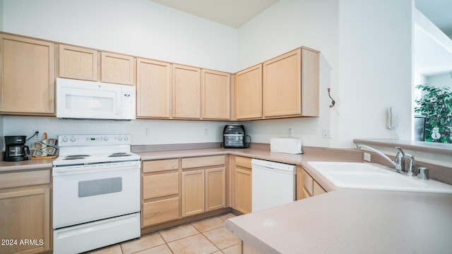 kitchen featuring white appliances, sink, light tile patterned floors, light brown cabinetry, and kitchen peninsula